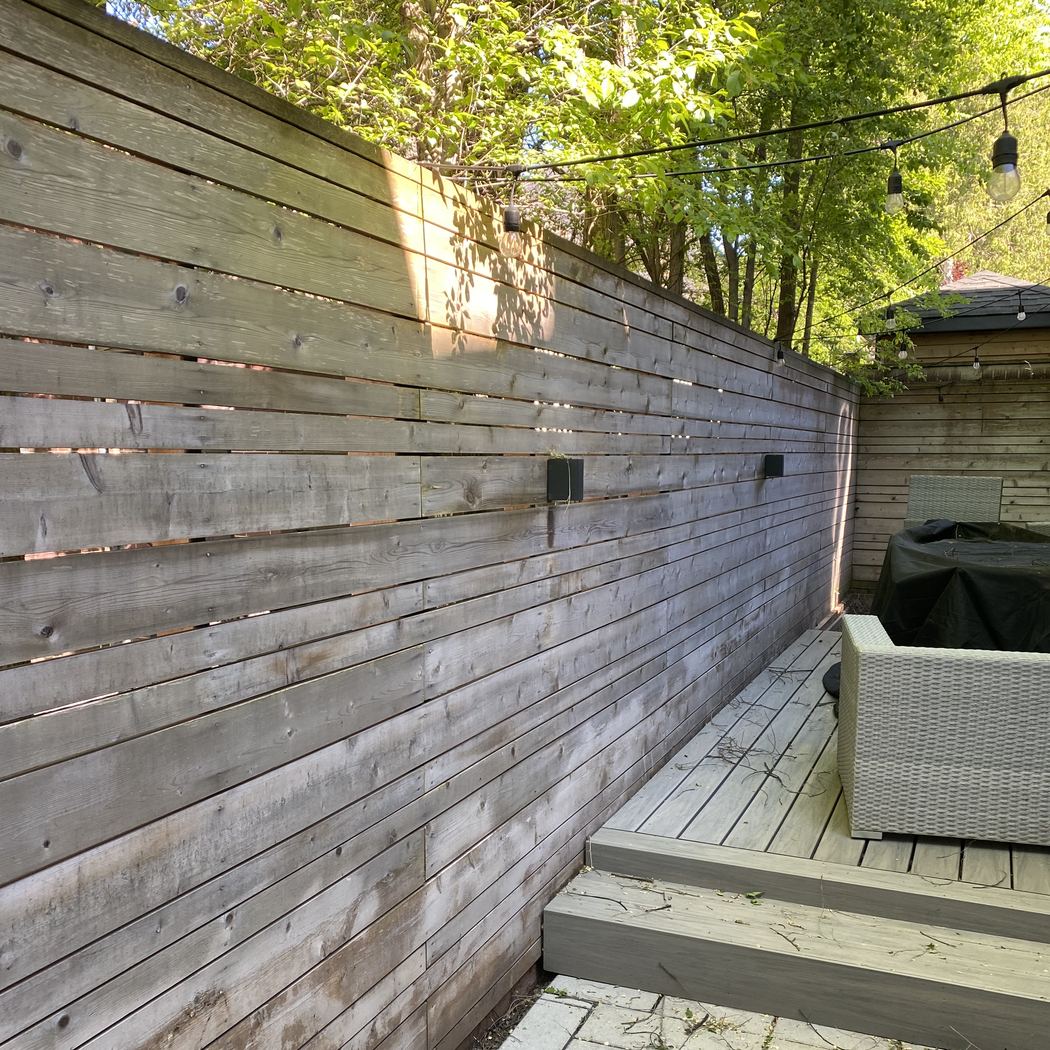 Greyed cedar privacy fence before staining