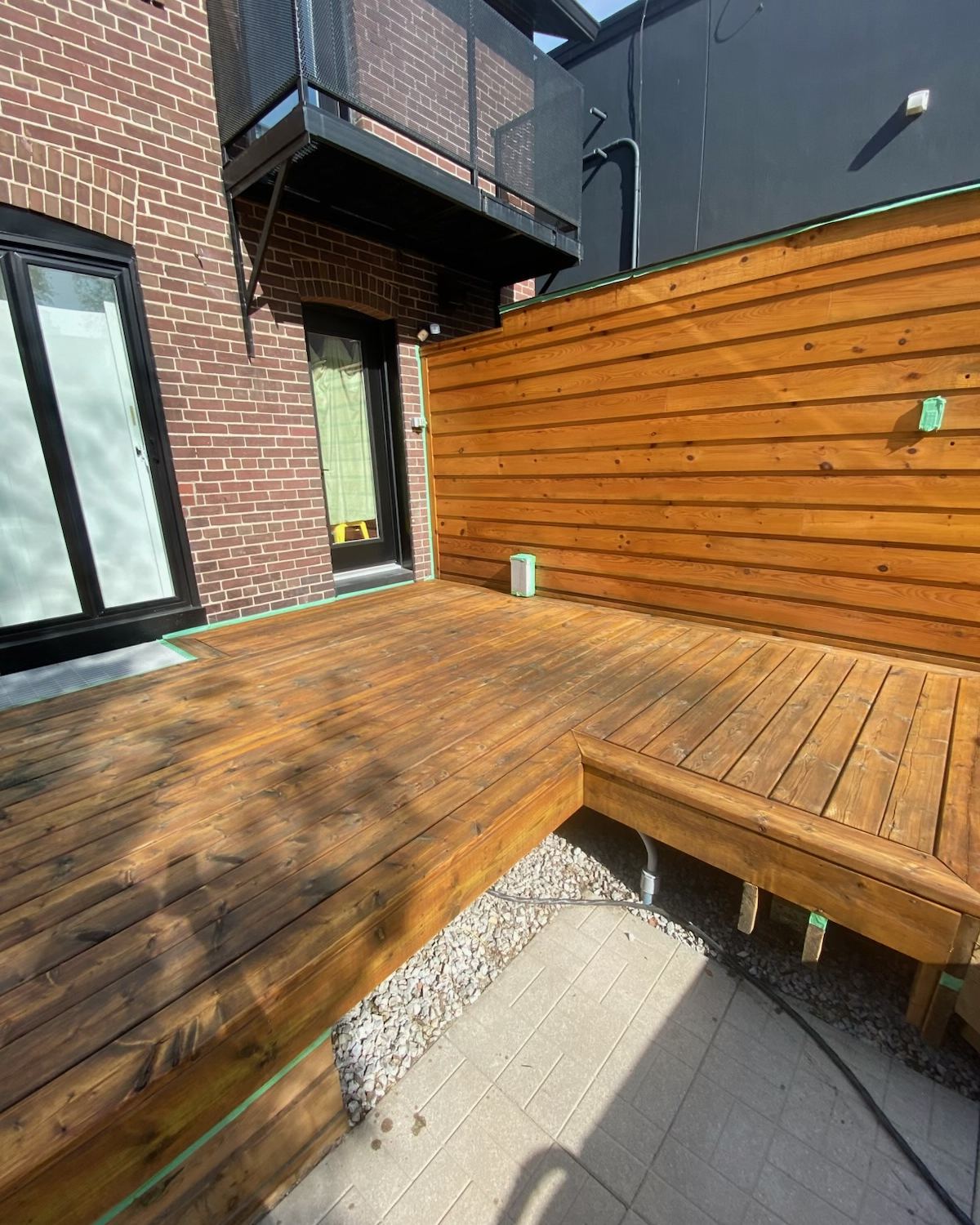 Freshly stained deck and cedar privacy wall in a Toronto backyard
