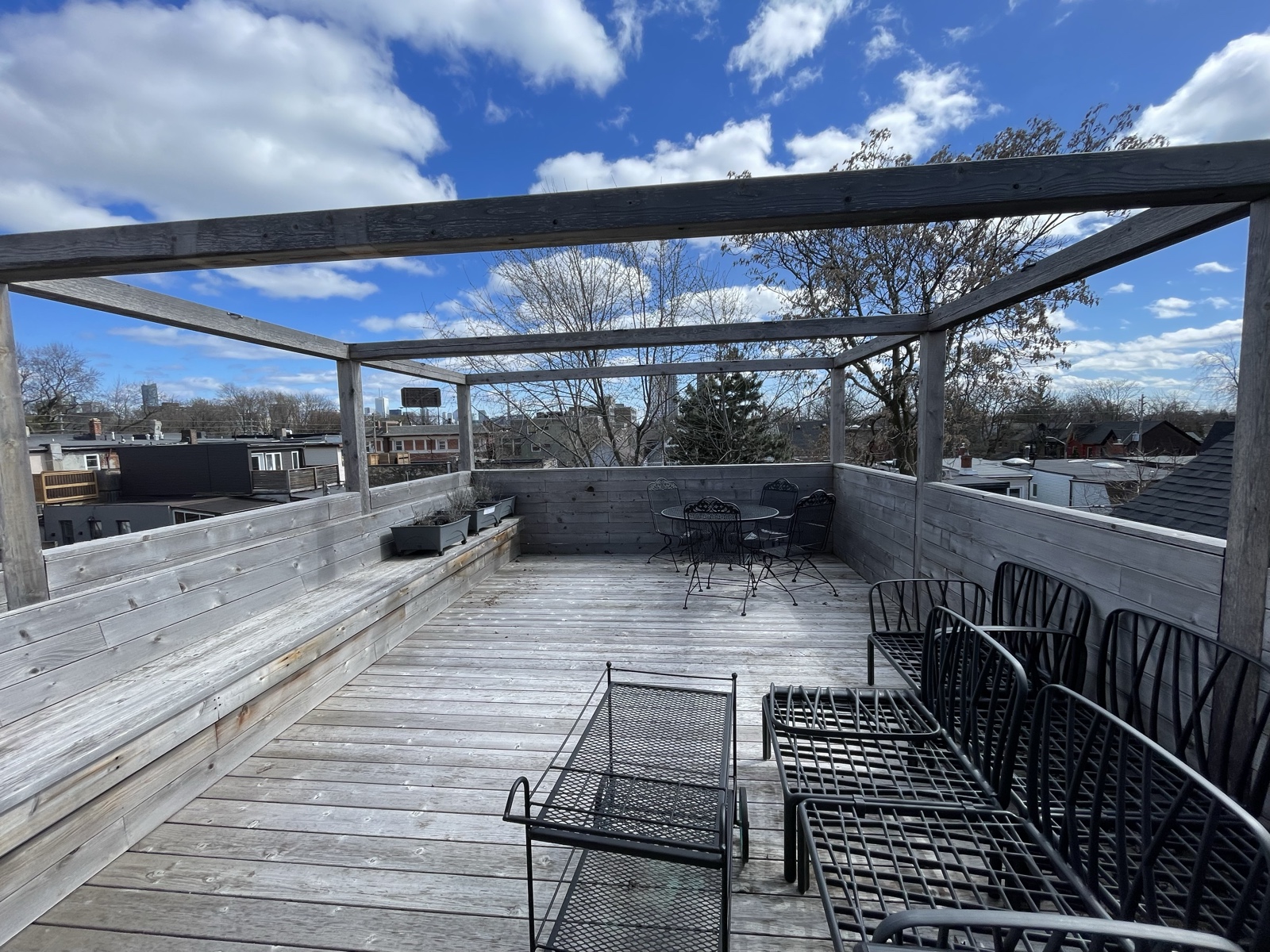 Weathered rooftop pergola deck before restoration