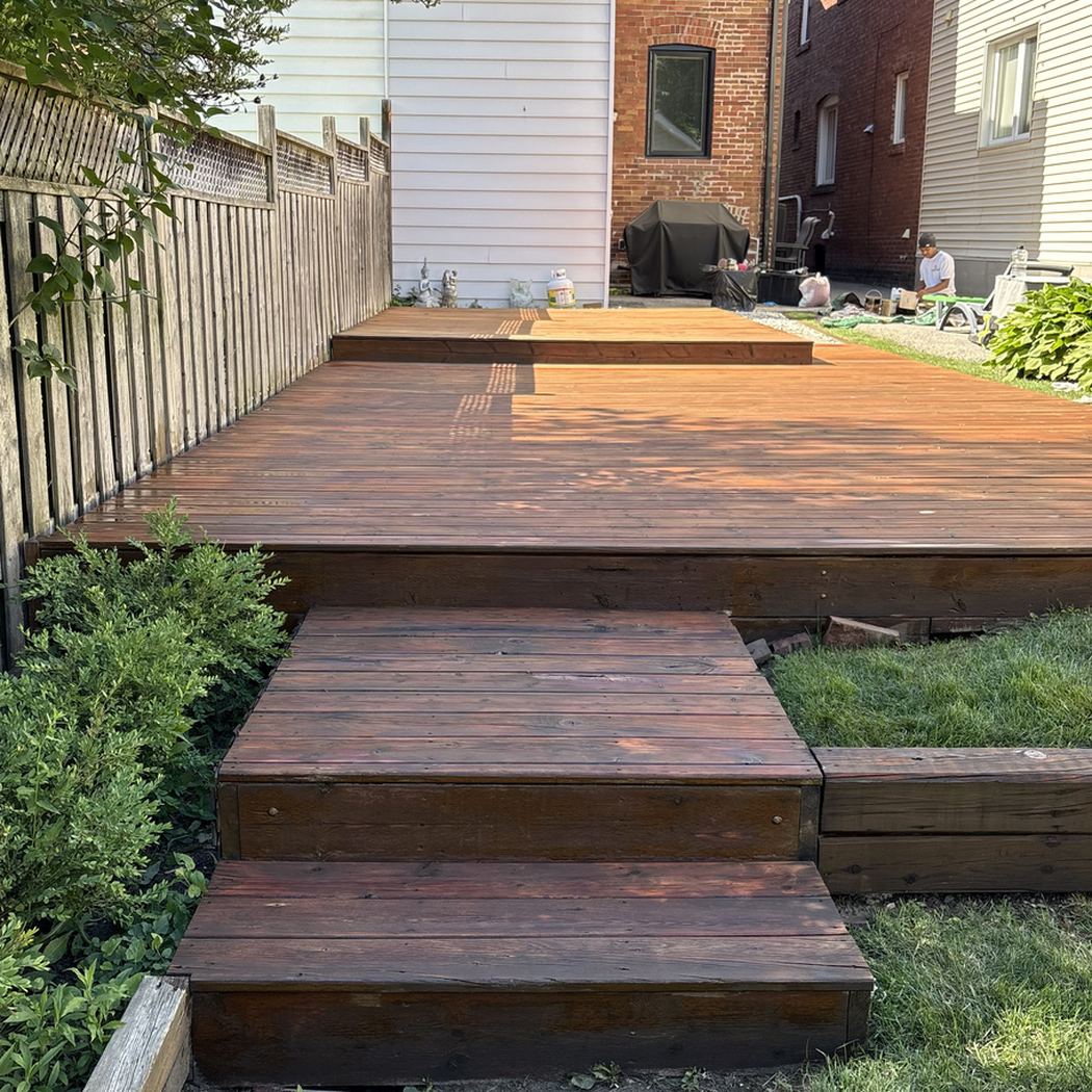 Backyard deck refinished with rich brown stain